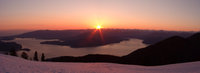 setting sun in snow mountains 